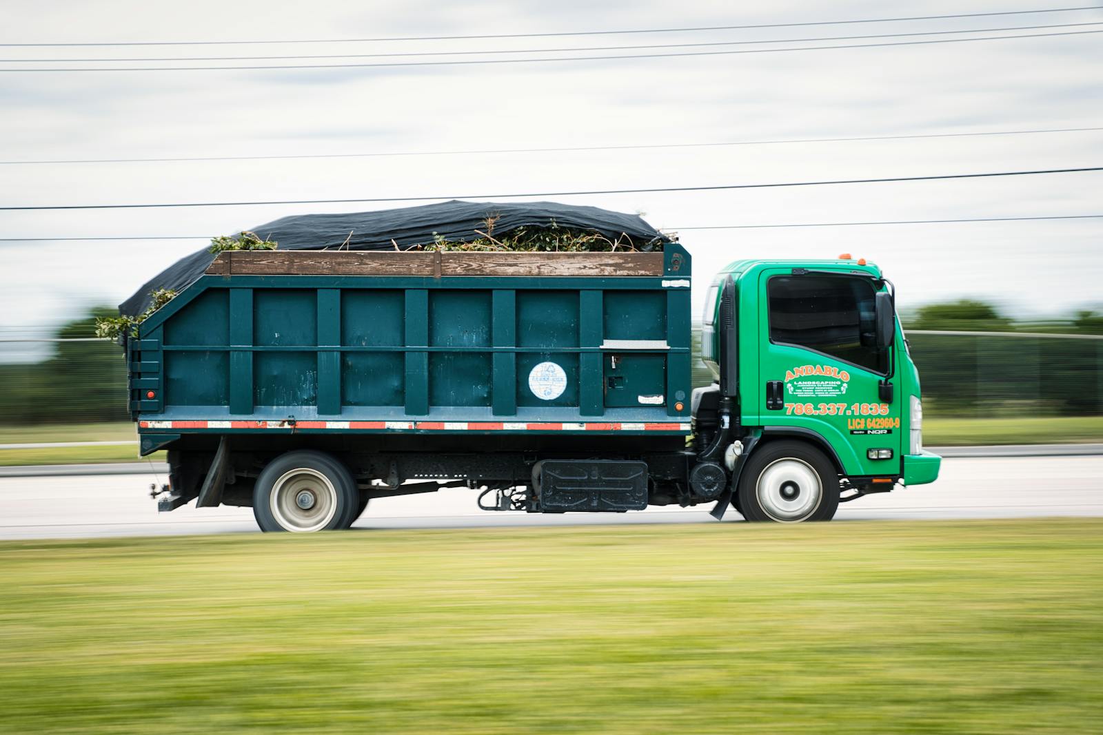 Pickup truck bed loaded with yard waste ready for haul-off
